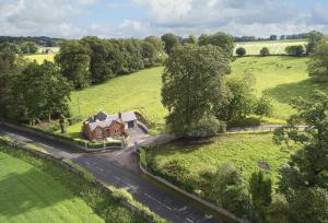an aerial view of a house in a field at Netherwood Lodge in Dumfries