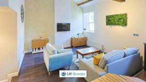 a living room with two couches and a tv at Great location-Pet friendly Contractors welcome in Whitehaven