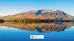 a mountain reflection in the water with the words ufs resorts at Great location-Pet friendly Contractors welcome in Whitehaven