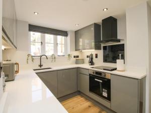 a kitchen with black and white cabinets and a sink at The Office in Telford