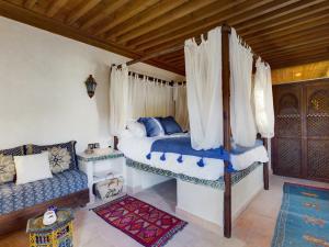 - une chambre avec un lit et un canapé dans l'établissement DAR AL AMAL, à Marrakech