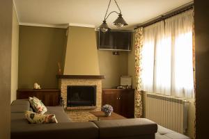 a living room with a couch and a fireplace at Apartamentos Ohana in Jadraque +94 photos