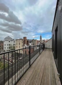 a wooden deck with a view of a city at Laila Penthouse in Antwerp