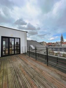 a wooden deck with a bench on top of a building at Laila Penthouse in Antwerp