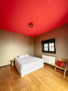 a bedroom with a bed and a red ceiling at Laila Penthouse in Antwerp