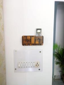 a lightswitch on a wall with a box on it at Kridha holidays homestay with kitchen in Vrindāvan