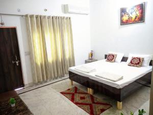 a bedroom with a bed in a room at Kridha holidays homestay with kitchen in Vrindāvan