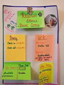 a group of signs on a refrigerator with writing on it at Kridha holidays homestay with kitchen in Vrindāvan