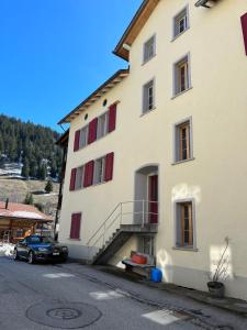 a building with a car parked in front of it at Charisma Peist Act-Sports Arosa in Peist