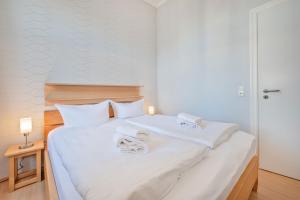 Postel nebo postele na pokoji v ubytování Villa Vineta Wohnung 203
