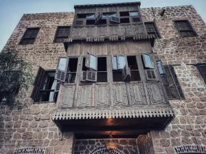 a tall building with a wooden balcony on it at El Quseir Hotel in Quseir