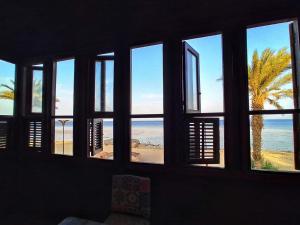 a room with a window with a view of the beach at El Quseir Hotel in Quseir