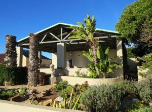 a house with atropical garden in front of it at Polka & Nollies in Port Nolloth