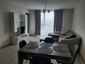 a living room with a table and a couch at Апартамент Deluxe 7 in Saints Constantine and Helena