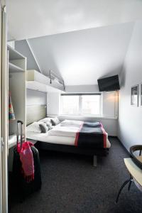 a bedroom with a large bed in a room at Cabinn Scandinavia in Copenhagen