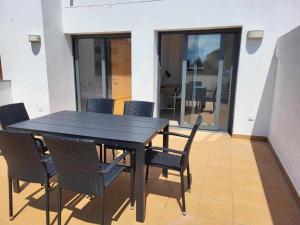 a black dining table and chairs in a room at Roses Casc Antic SL Sabater 3 in Roses