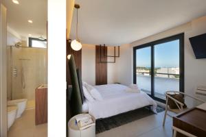 a bedroom with a bed and a bathroom with a window at Bed&Belvedere in Otranto