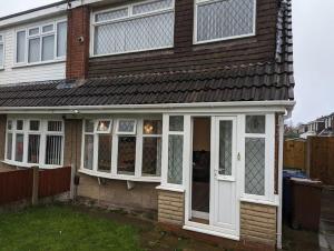 a house with a white door and windows at Home away from home in Leigh