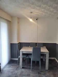 a dining room with a table and chairs at Home away from home in Leigh