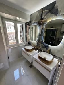 a bathroom with two sinks and a large mirror at Madonna suites in Split