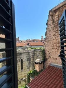 a view from the balcony of a building with a brick wall at Madonna suites in Split