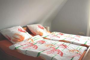 a bed with two pillows on top of it at Pauls, Ferienwohnung in Celle