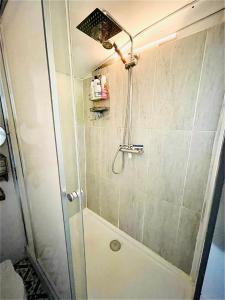 a shower with a glass door in a bathroom at Boutique Boat Stays in Bath