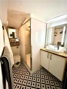 a small bathroom with a shower and a sink at Boutique Boat Stays in Bath