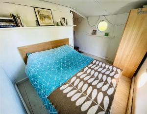 a small bedroom with a bed in a small room at Boutique Boat Stays in Bath