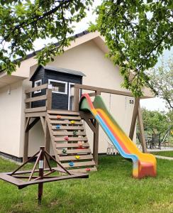 a play house with a slide in the yard at Domček v záhrade in Liptovský Mikuláš