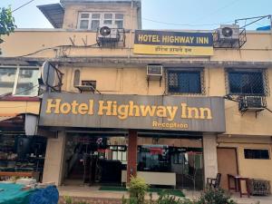 a hotel highway inn sign on the side of a building at Hotel Highway Inn Andheri East in Mumbai