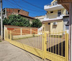 a yellow gate in front of a house at Town Square House in Gevgelija