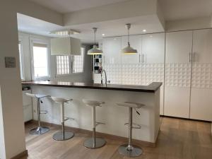 a kitchen with a counter and bar stools at Feeling Marbella in Marbella