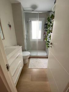 a bathroom with a shower and a toilet and a window at Feeling Marbella in Marbella