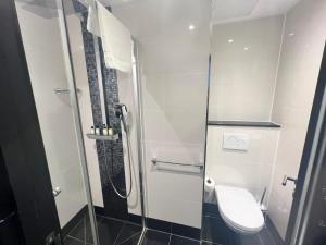 a bathroom with a toilet and a shower at Great St Helen Hotel in London