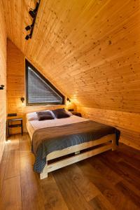 sypialnia z łóżkiem w drewnianym domku w obiekcie Sielski Chill Mazury w Olsztynku
