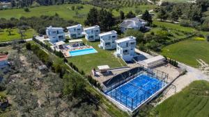 an aerial view of a house with a swimming pool at Blue Avenue in Paliouri