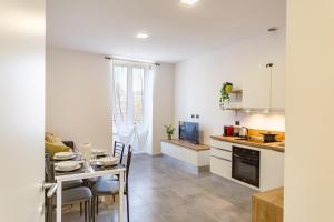 a kitchen and dining room with a table and a dining room at KHL APARTMENTS - SanSiro, Milano in Milan