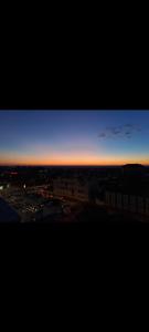 a view of a city at sunset at Happy Rental Apartments 1 in Craiova