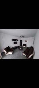 a living room with two beds and a fireplace at Happy Rental Apartments 1 in Craiova