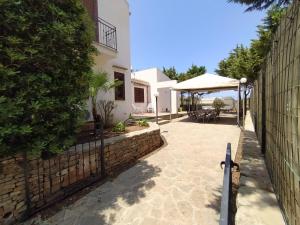 a courtyard of a house with a fence at SanVitoTour- Residence Il Baglio in San Vito lo Capo