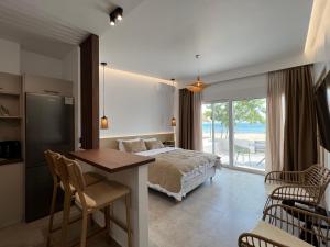 a bedroom with a bed and a table and chairs at Penthouse & apartments by the Sea airport Airstay in Artemida