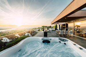 a hot tub on the balcony of a house at Traumblick trifft Luxus! in Weitersburg
