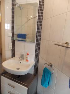 a bathroom with a sink and a shower at Ferienwohnung Sarah & Thorsten Blum in Kelberg