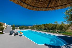 a swimming pool in a villa with a view at Cave Sand in Monolithos