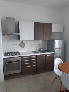 a kitchen with a sink and a stove top oven at Arcomagno Guest House in San Nicola Arcella +18 photos