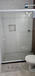 a bathroom with a shower and a toilet at Pousada Viva Mar in Saquarema