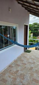a house with a blue rope on a patio at Pousada Viva Mar in Saquarema