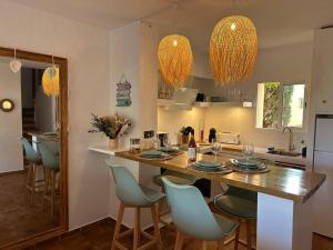 a kitchen with a table and chairs in a kitchen at Casita Vista Mar Duplex - Son Xoriguer in Son Xoriguer