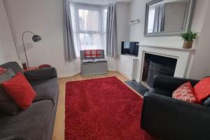 a living room with a couch and a fireplace at Entire House With Garden & Parking Nr Ashford Int in Ashford